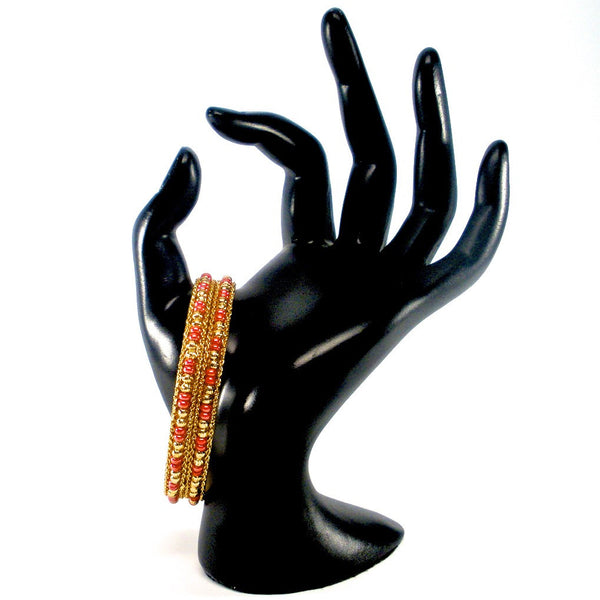 pair of gold bangles with beads