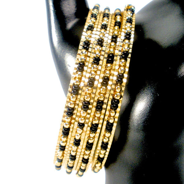 thin gold bangles with black and gold beads