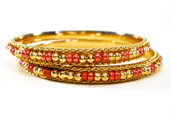 pair of gold bangles with beads