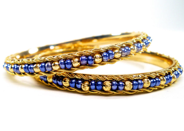 pair of gold bangles with beads