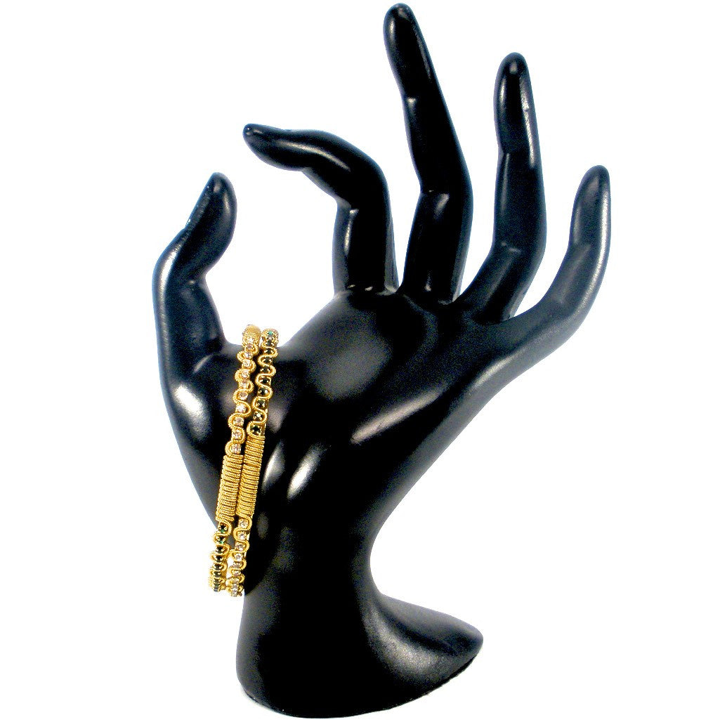 gold bangles with white and green stones