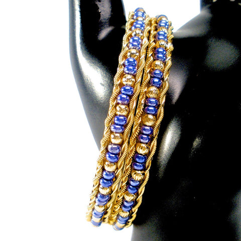 pair of gold bangles with beads