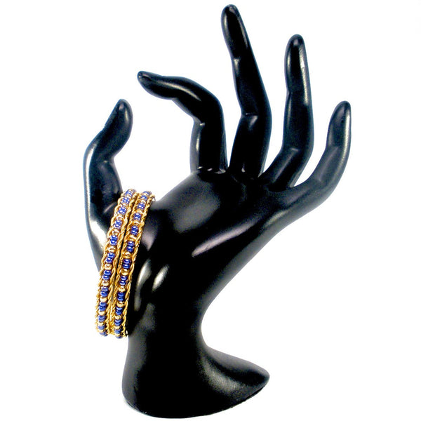 pair of gold bangles with beads
