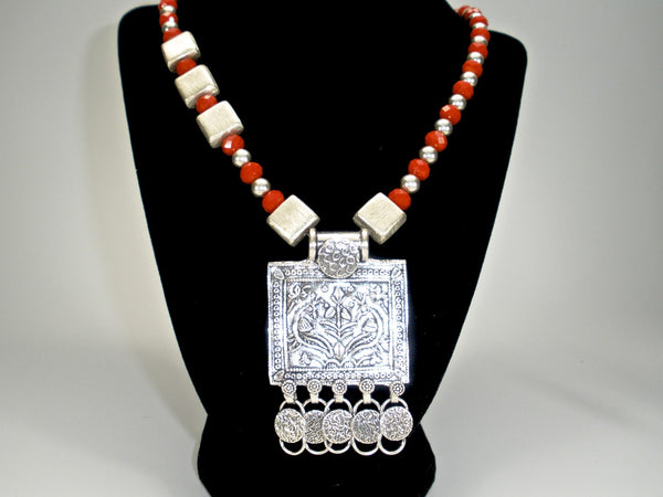 orange crystals with tribal pendant and square silver spacers